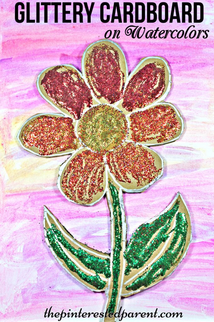 Glittery cardboard flower over watercolor paints - a pretty spring or summer arts & crafts project for kids..