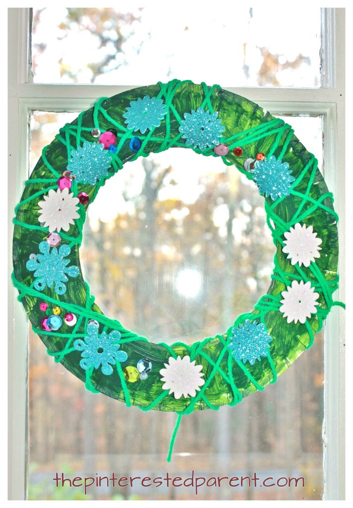 Yarn wrapped paper plate Christmas wreath - winter kid's arts and crafts and fine motor activity