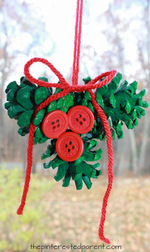 Pine cone holly ornament. Winter and Christmas arts and crafts for kids and preschoolers. Nature and button crafts. Painted pinecones