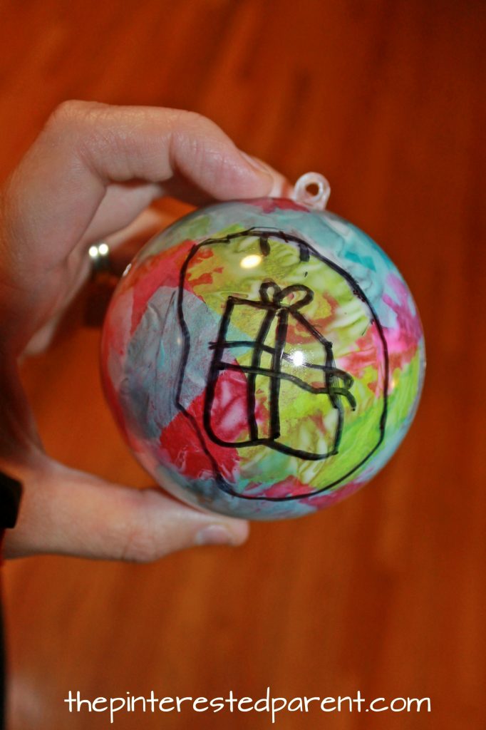 What would be better on your Christmas tree than a hand drawn ornament made by your child. Christmas and winter arts and crafts. Easy kid made ornaments with Sharpie and tissue paper.. 