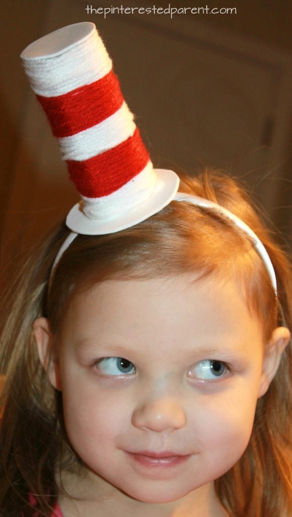  Toilet paper tube Dr. Seuss headband hat. Recycle cardboard rolls wrap with yarn for an easy Cat in the Hat inspired arts and craft project for the kids. A great fine motor activity as well.