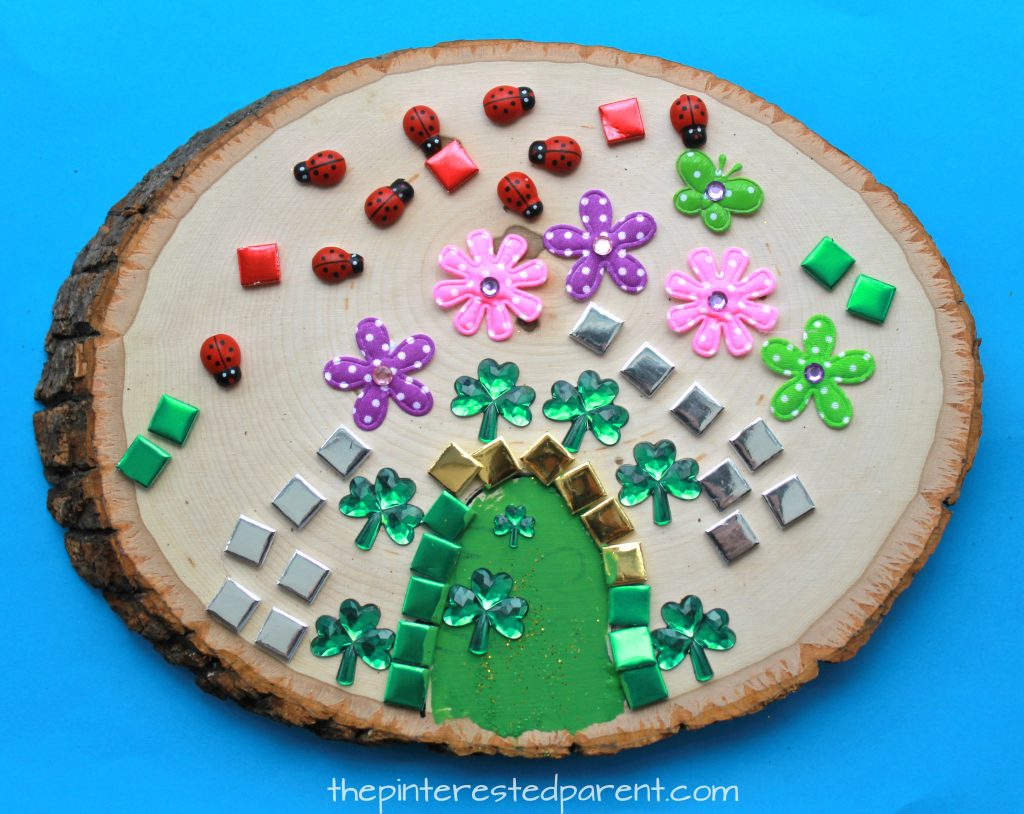 Wood Slab Leprechaun house and door. St Patrick's Day arts and crafts for kids. Paint, stickers, nature and gemstones made these pretty doors.