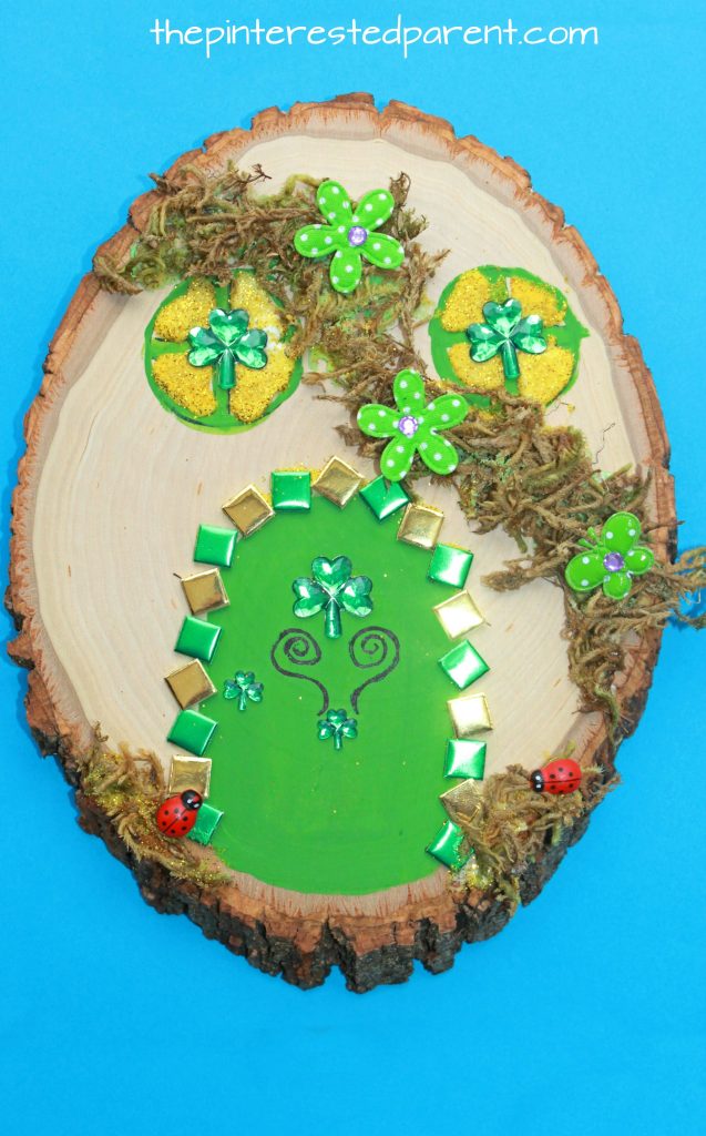Wood Slab Leprechaun house and door. St Patrick's Day arts and crafts for kids. Paint, stickers, nature and gemstones made these pretty doors. A fairy house could be made as well.