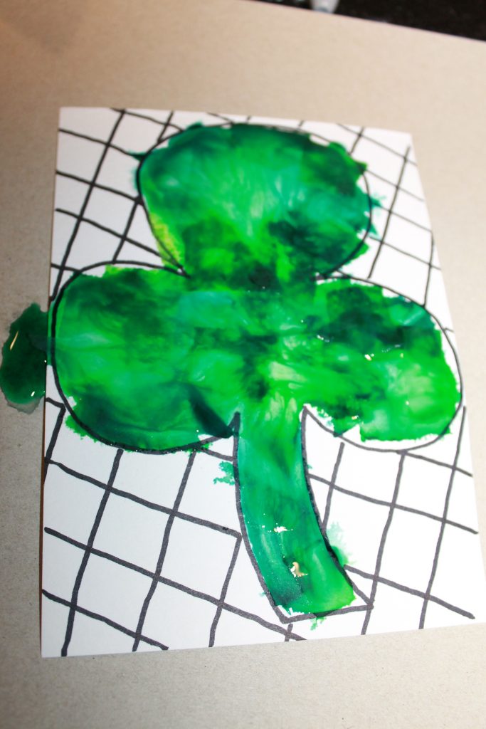 Bleeding tissue paper painted shamrocks for St. Patrick's Day. Easy arts and crafts art ideas for preschoolers and kids.