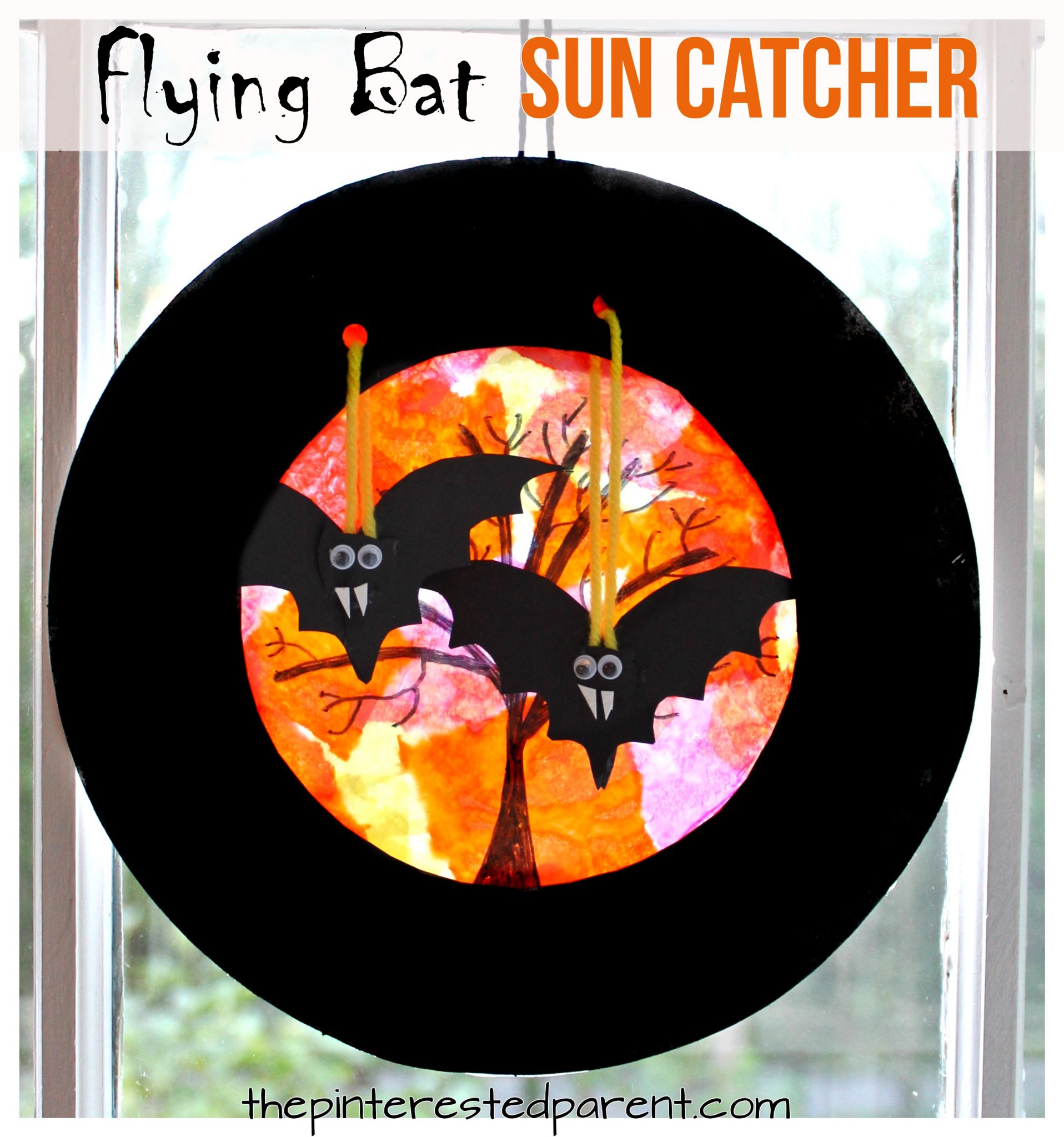 Paper plate swinging flying bats sun catcher - Halloween arts & crafts for kids.